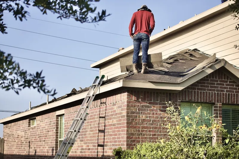 Professional roofer working on a residential roof in South Land Park